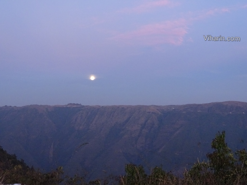 Viharin.com- Moon overlooking top of mountains
